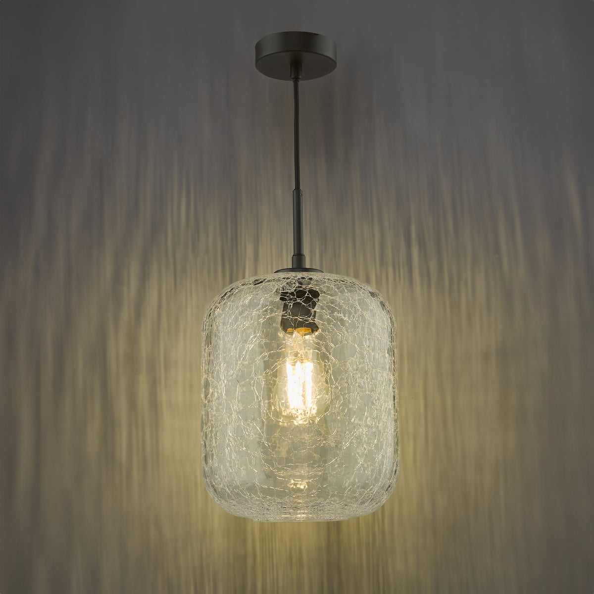 Cracked glass pendant light with a black ceiling rose and a visible filament bulb