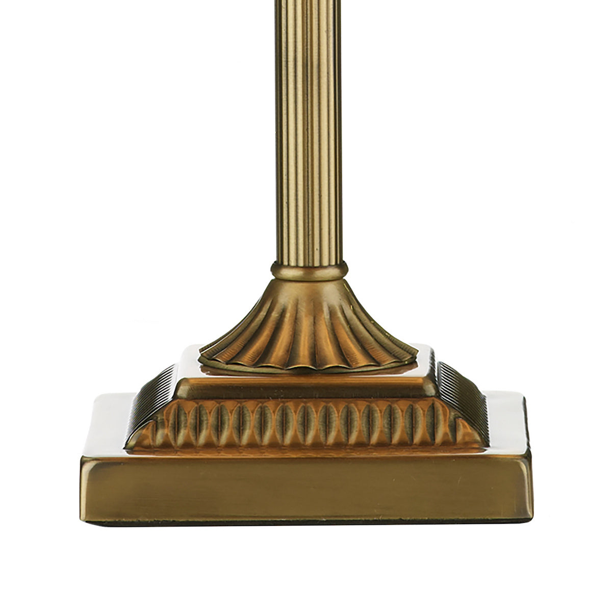 Close-up of a bronze lamp base with fluted column and decorative square pedestal.
