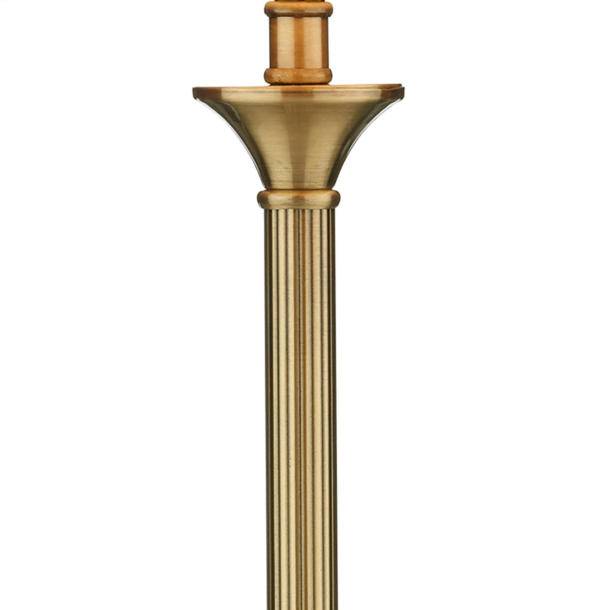 Close-up of a brass lamp post with fluted details and a decorative base.