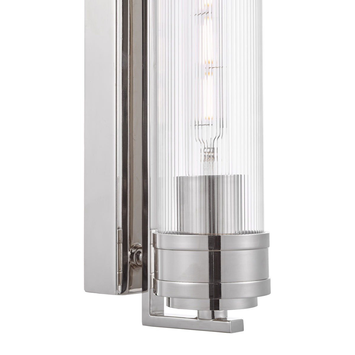 Polished nickel wall sconce with a ribbed glass shade and exposed filament bulb
