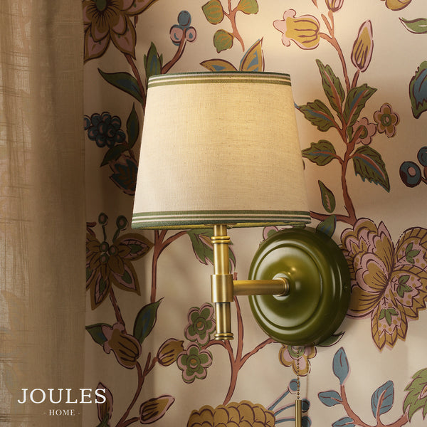 Joules Upton switched wall light in matt antique brass and matt green with a tapered linen shade
