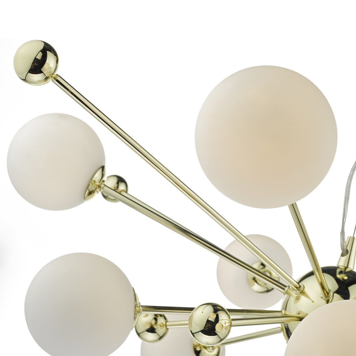 Close-up of a modern chandelier with gold arms and spherical white glass shades.