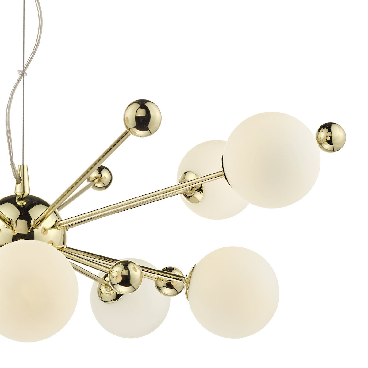 Close-up of a gold chandelier with multiple arms ending in white spherical lights and small gold spheres.