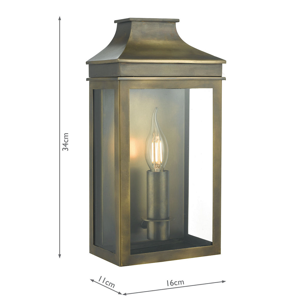 A rectangular outdoor wall light in an antique brass finish with clear glass panels and a candle-style bulb.