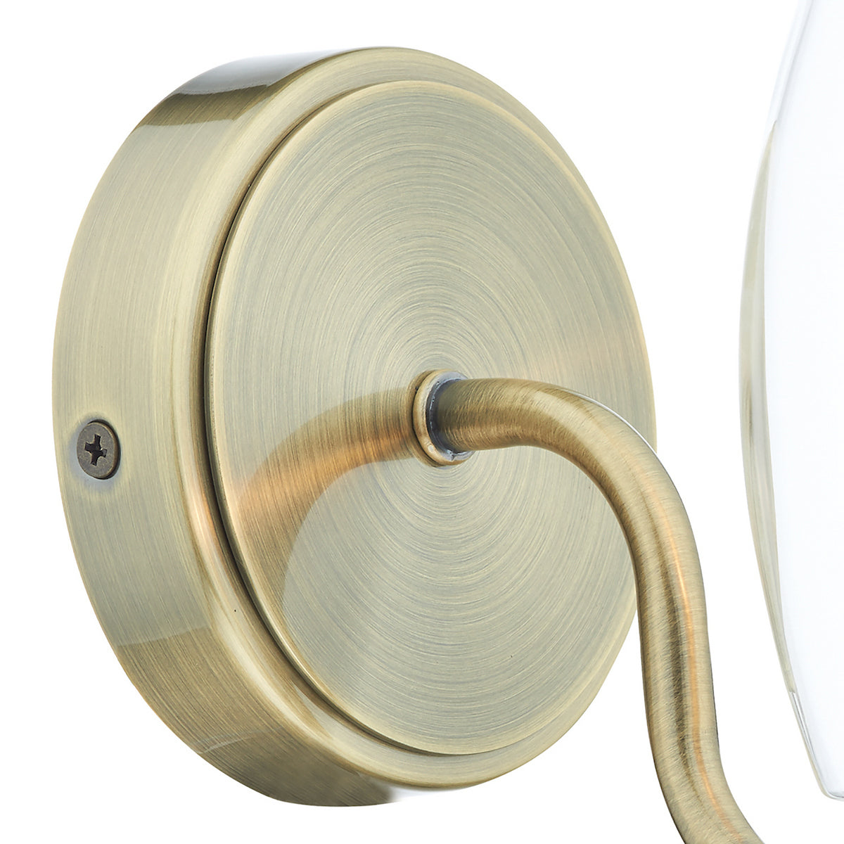 Close-up of a brass wall sconce base with a curved arm and a visible screw.