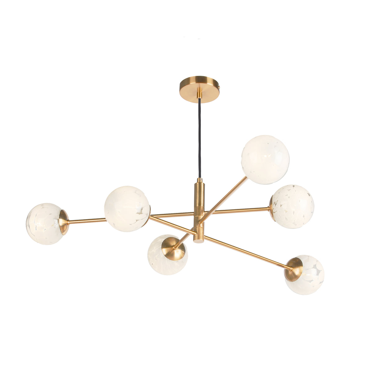 Modern brass chandelier with six white globe lights, each featuring a subtle speckled pattern.