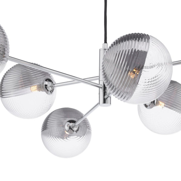 Modern chrome chandelier with six clear and ribbed glass globe shades, each holding an exposed bulb.