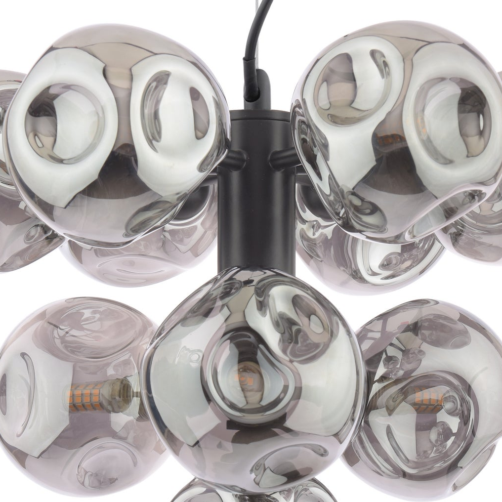 Close up of a chandelier with multiple grey glass globes and visible light bulbs