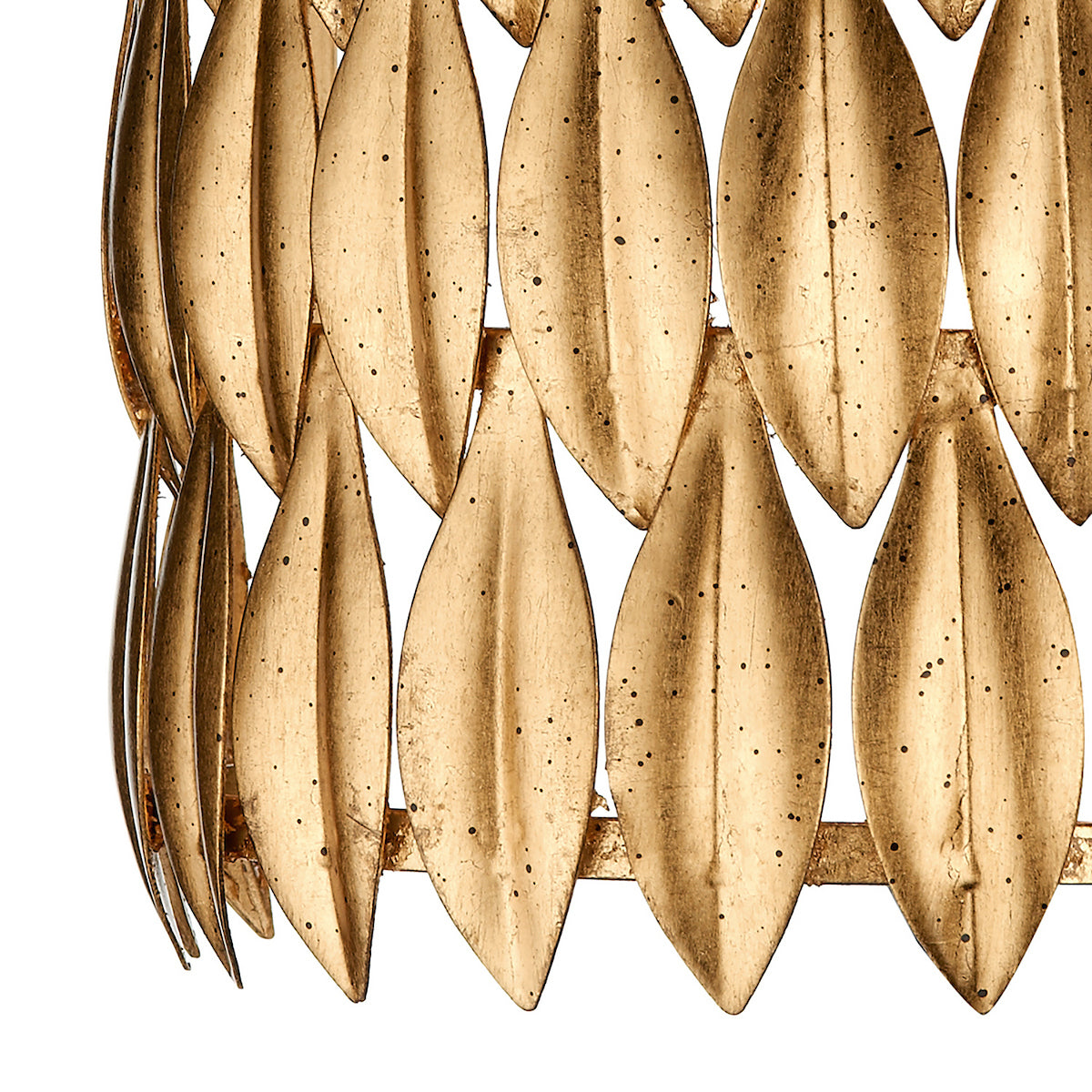 Close-up of a gold metal wall decor with leaf-shaped pieces arranged in rows.