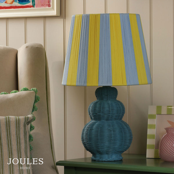 Joules Whitby table lamp with a matt blue woven base and a blue and yellow striped fabric shade