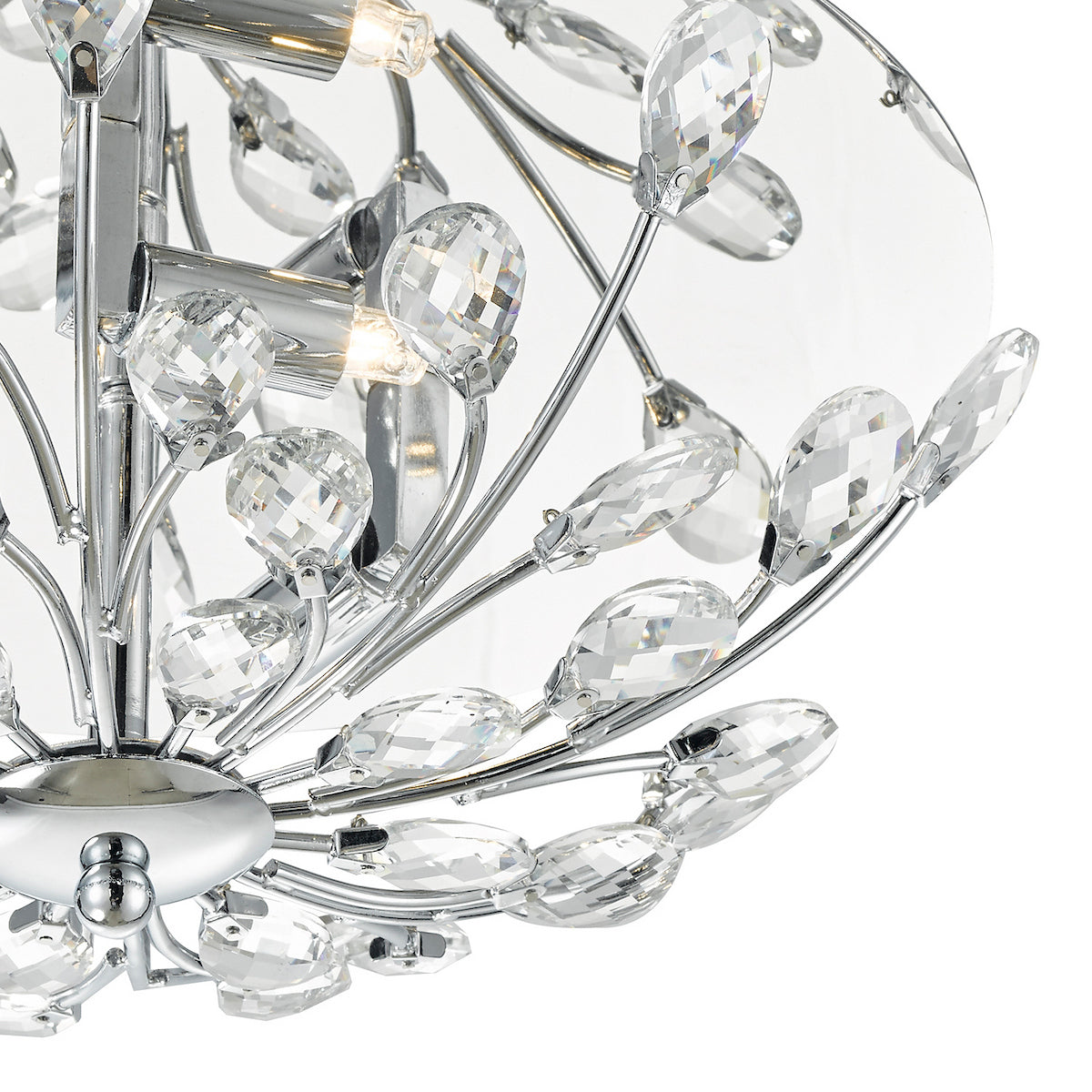 Close-up of a modern chandelier with chrome finish and clear crystal teardrop accents.