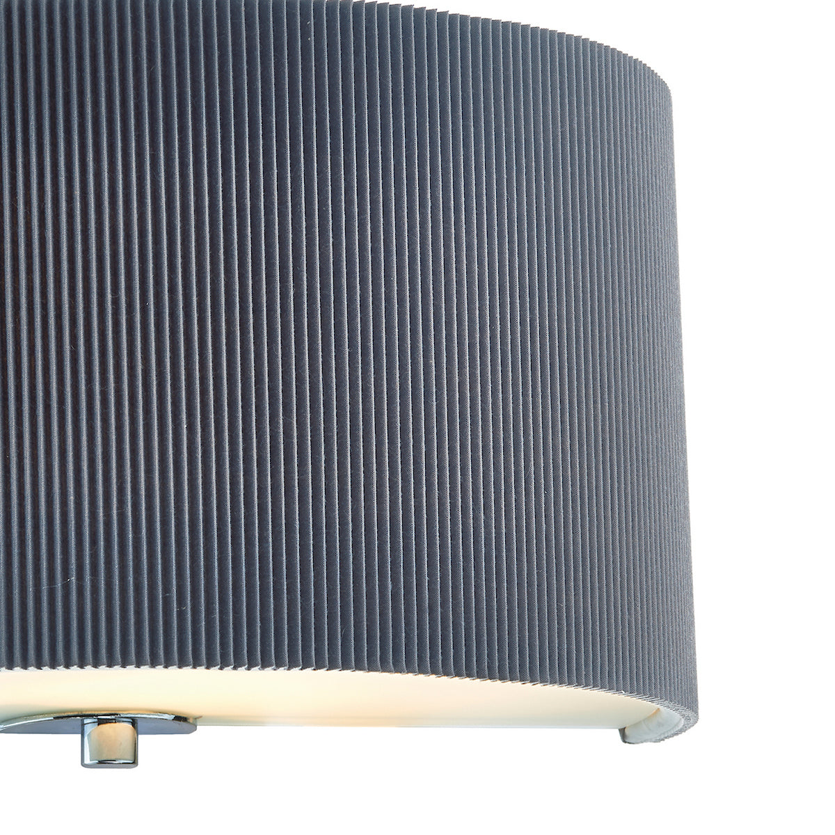 Close-up of a gray pleated lamp shade with a glowing light at the bottom.
