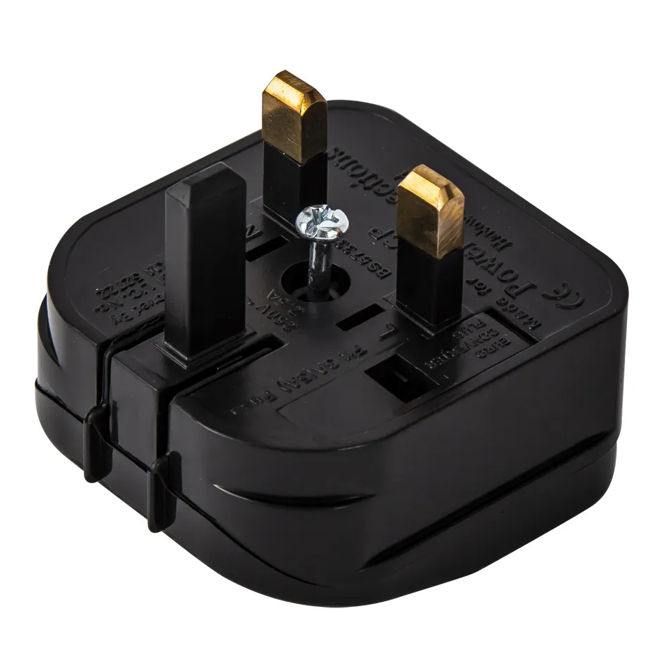 Black UK power plug adapter with three prongs, two brass and one black, on a white background