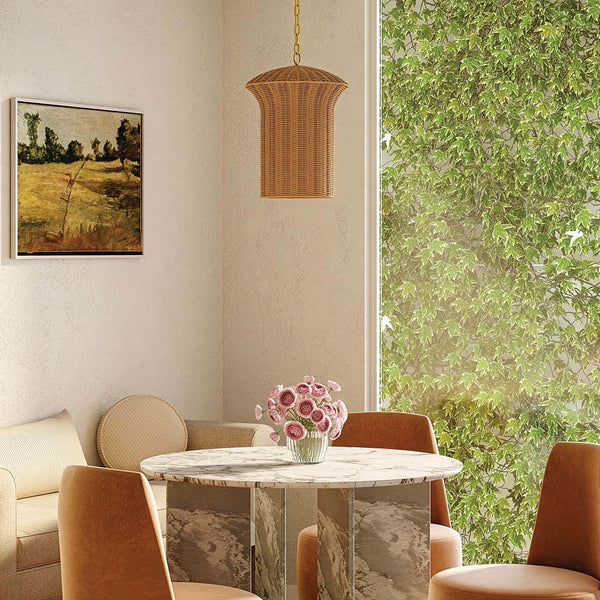 Alora Mood Kai small pendant with faux rattan shade and brushed gold metalwork hanging above a marble dining table