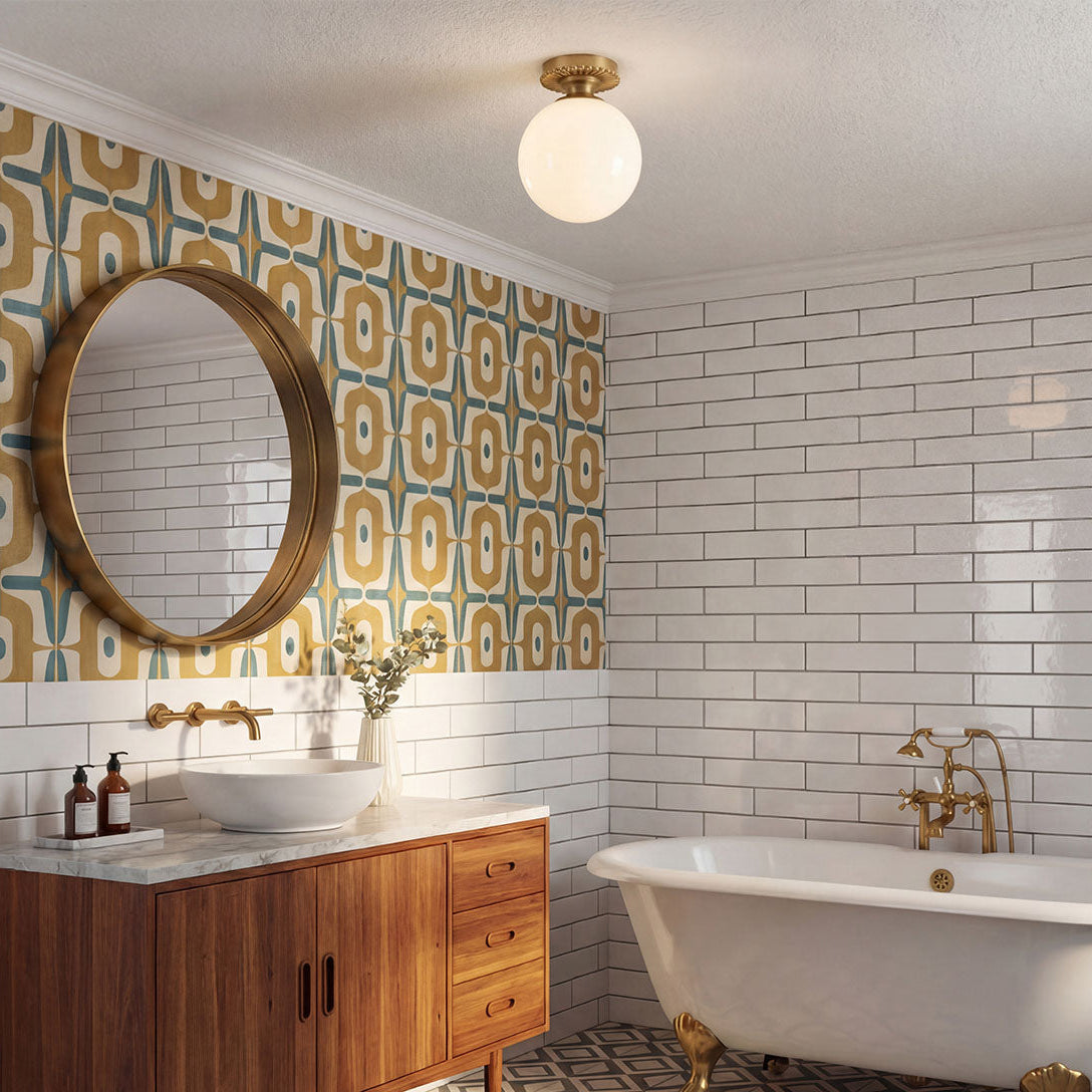 Alora Mood Otis IP44 ceiling light in brushed gold with opal glass globe in a bathroom