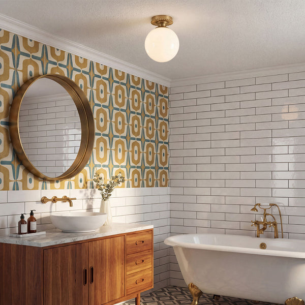 Alora Mood Otis IP44 ceiling light in brushed gold with opal glass globe in a bathroom