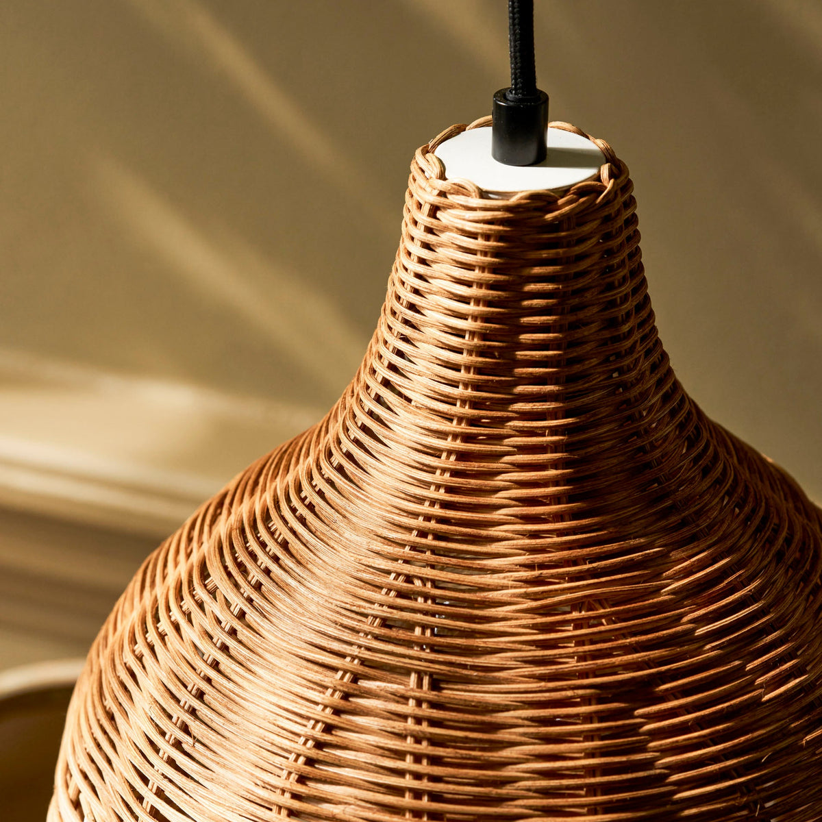 Close up of the woven rattan texture of the Mouldon Small Pendant in Rattan by Garden Trading Lighting