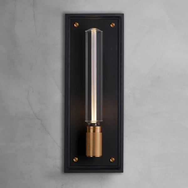 Black rectangular wall sconce with a clear cylindrical bulb and a brass base