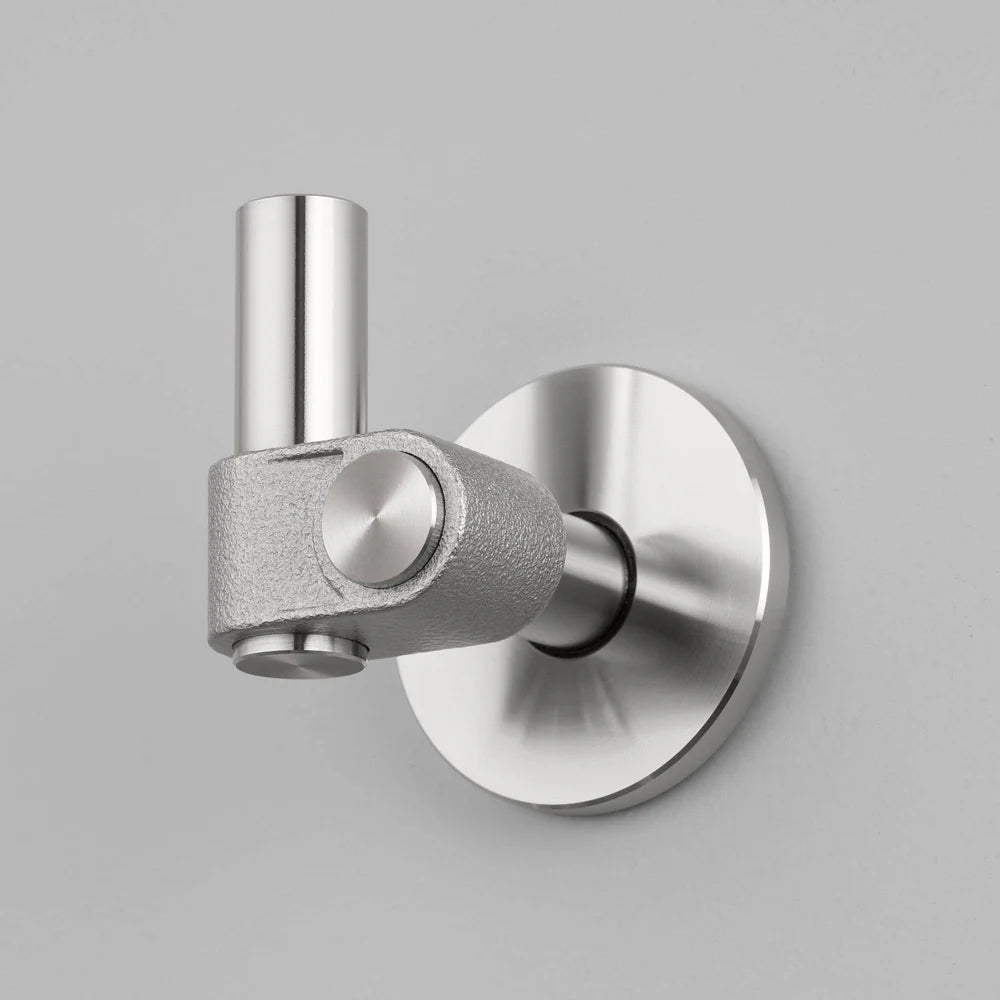 Brushed metal wall-mounted hook with a cylindrical upright and a textured L-shaped arm