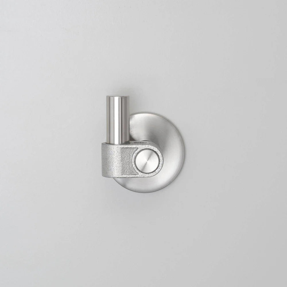 Brushed metal wall hook with a cylindrical post and a circular base