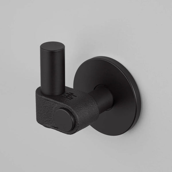 Black metal coat hook with a cylindrical top and a textured base