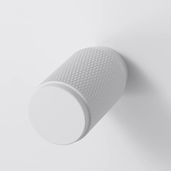 White cylindrical knob with a textured diamond pattern on its side