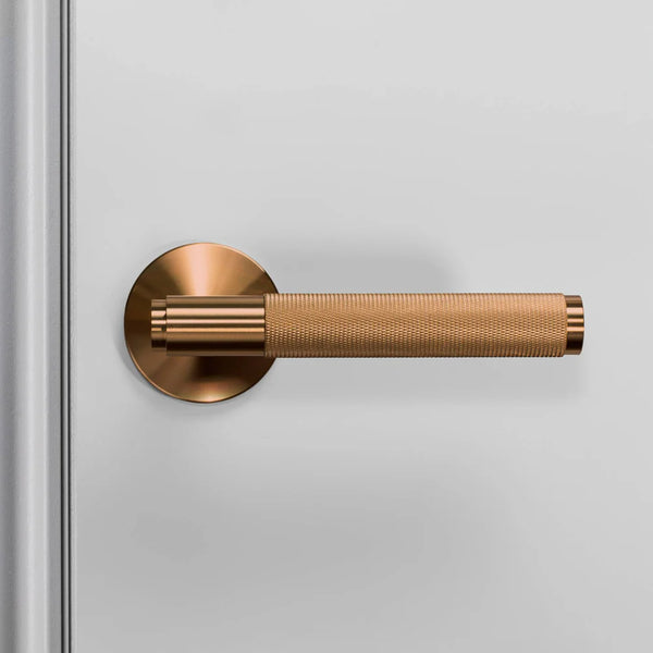 Bronze door handle on a white door