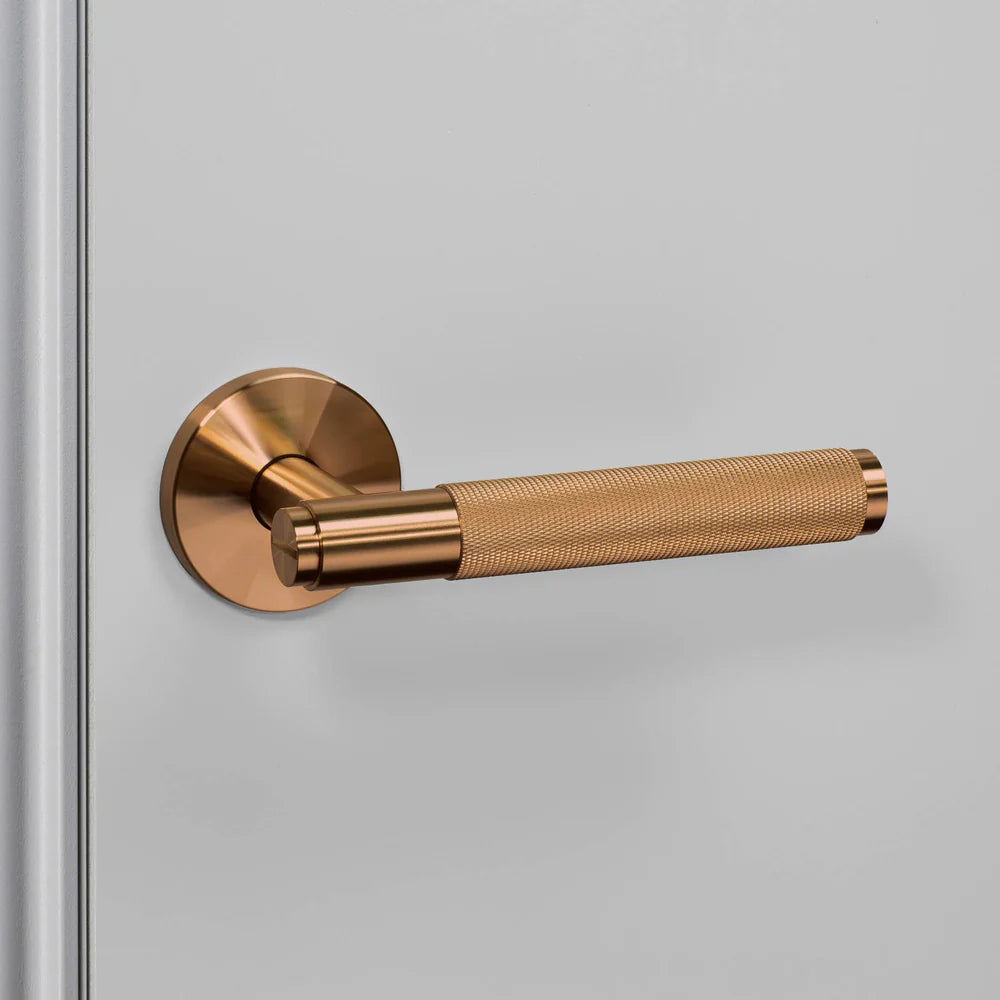 Bronze door handle with a textured grip
