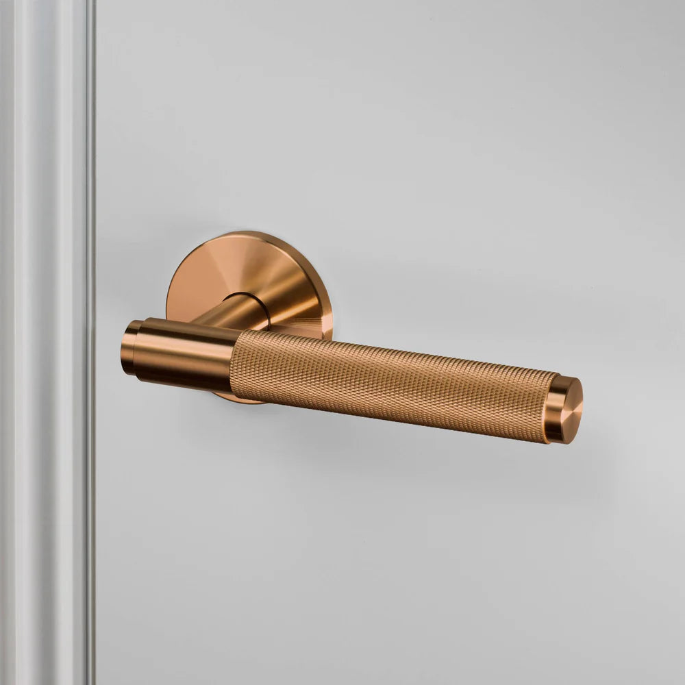 Bronze door handle with a textured grip