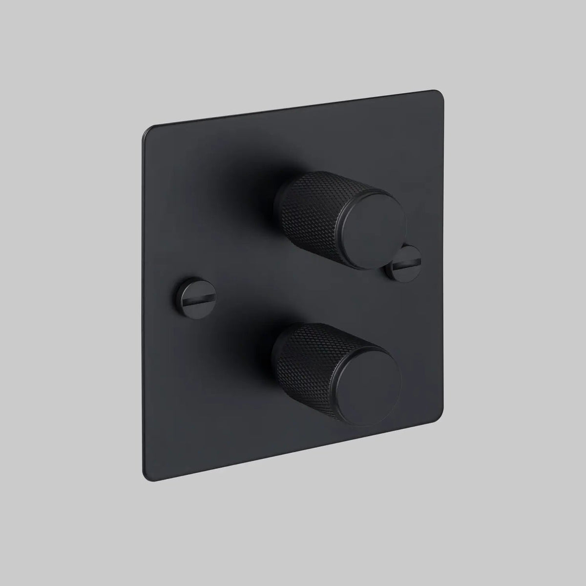 Black square dimmer switch with two textured circular knobs and two flathead screws