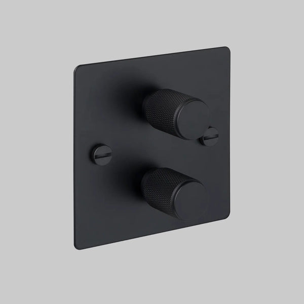 Black square dimmer switch with two textured circular knobs and two flathead screws