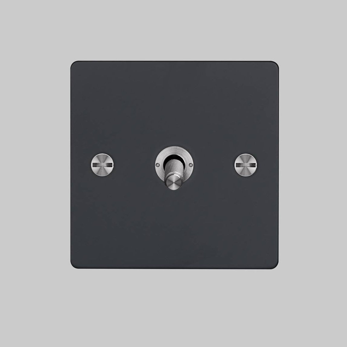 Matte black single toggle light switch with brushed metal toggle and screw heads