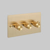 Three Gang 2 Way Dimmer Light Switch in Brass with Cross Cut Knurled Knobs