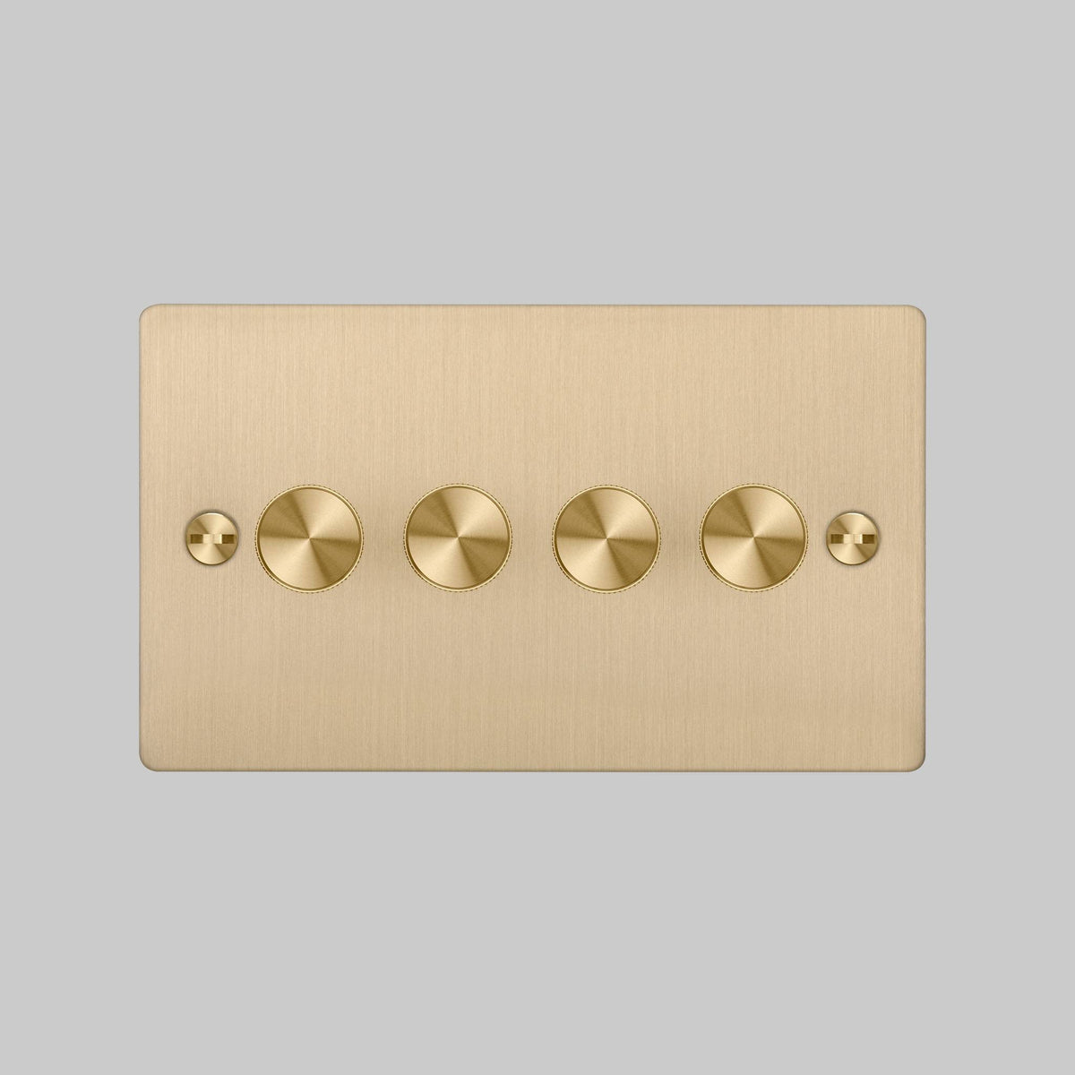 Brushed brass four-gang dimmer switch with four round dimmer knobs and two flathead screws