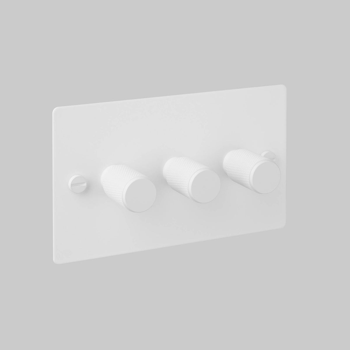 White triple dimmer switch with three textured rotary knobs and a visible screw on the left
