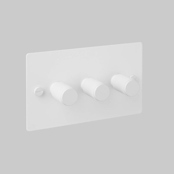 White triple dimmer switch with three textured rotary knobs and a visible screw on the left