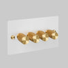 Four Gang 2 Way Dimmer Light Switch in White with Brass Cross Cut Knurled Knobs