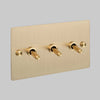 Three Gang 2 Way Light Switch in Brass with Cross Cut Knurled Toggles