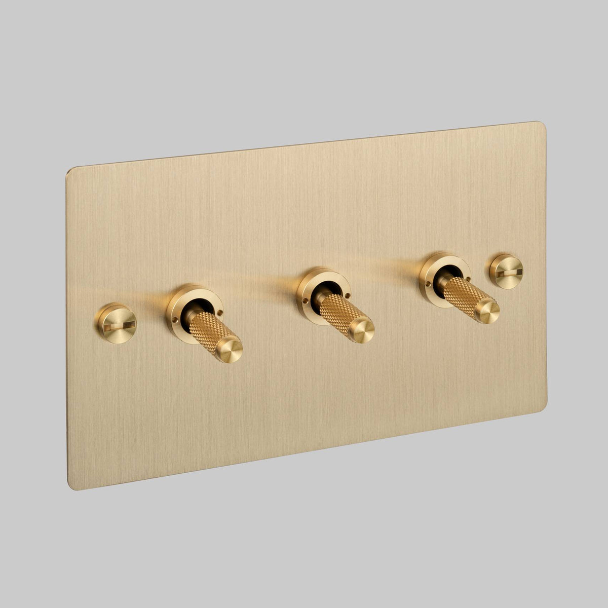 Three Gang 2 Way Light Switch in Brass with Cross Cut Knurled Toggles