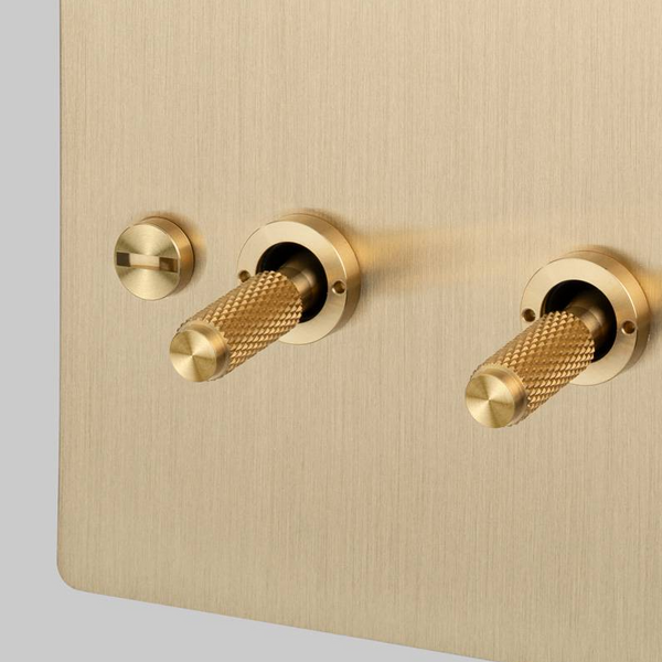 Four Gang 2 Way Light Switch in Brass with Cross Cut Knurled Toggles