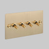 Four Gang 2 Way Light Switch in Brass with Cross Cut Knurled Toggles