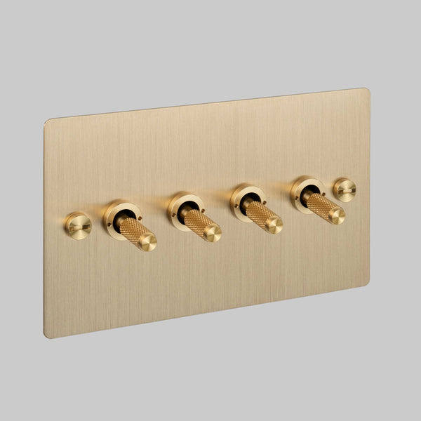 Four Gang 2 Way Light Switch in Brass with Cross Cut Knurled Toggles