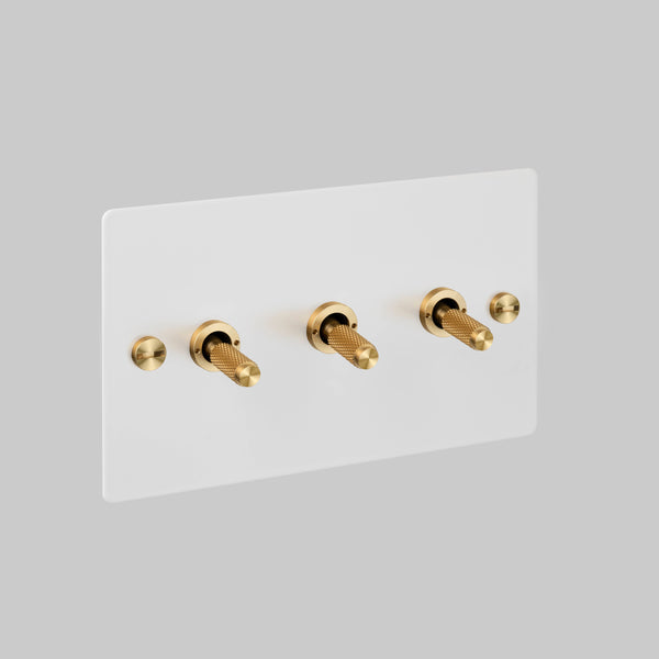 Three Gang 2 Way Light Switch in White with Brass Cross Cut Knurled Toggles