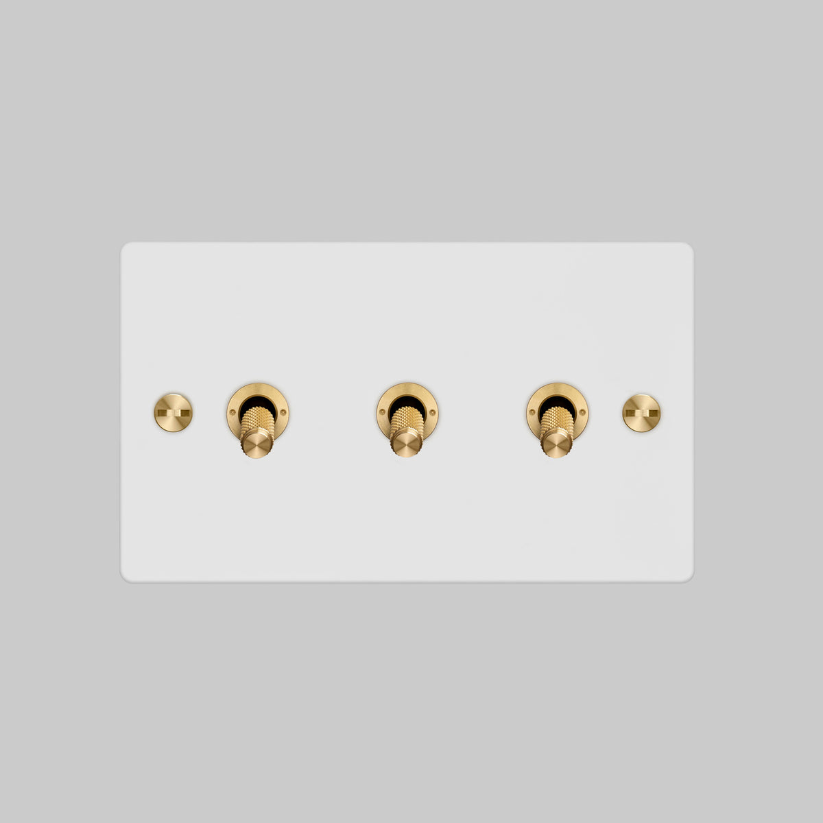 Three Gang 2 Way Light Switch in White with Brass Cross Cut Knurled Toggles