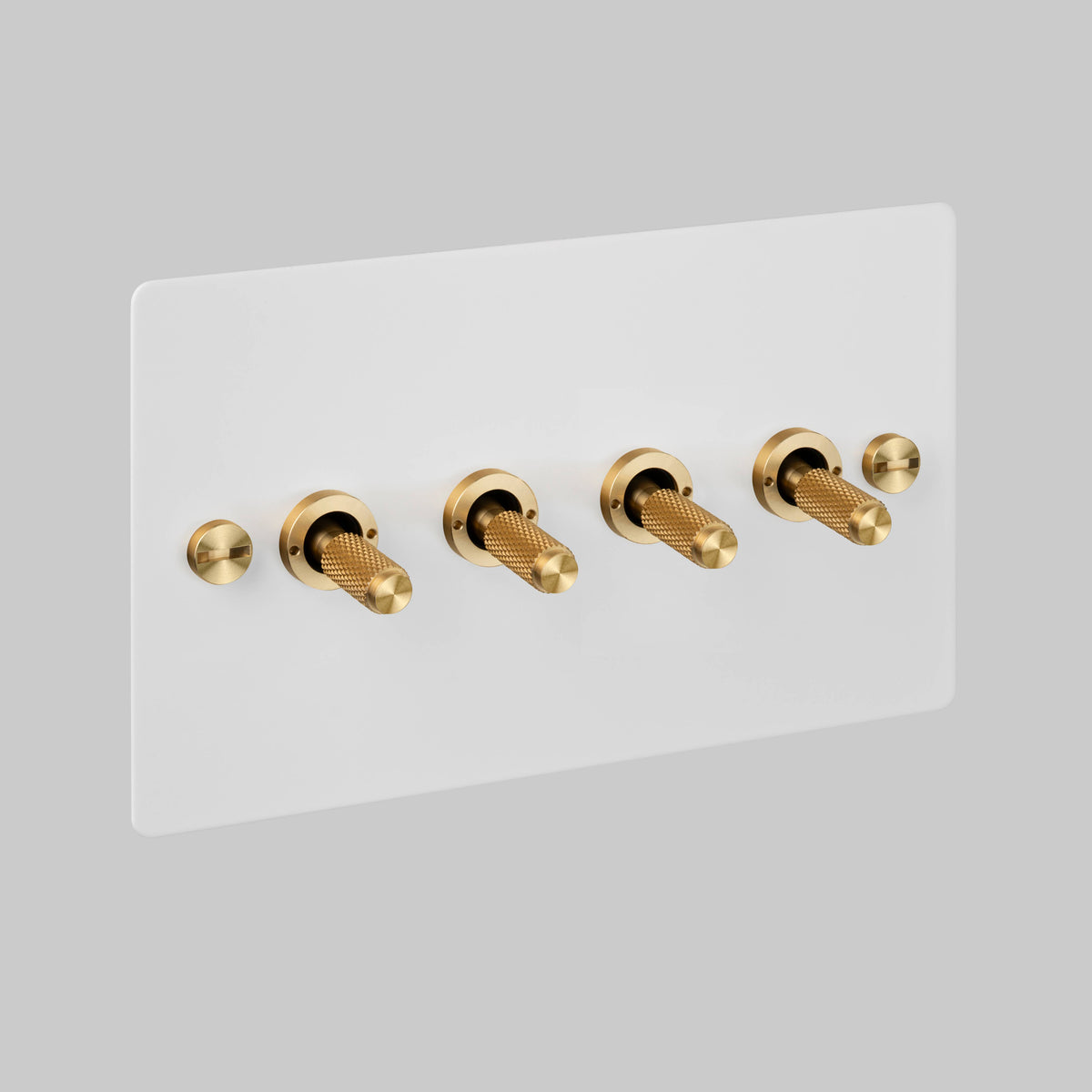 Four Gang 2 Way Light Switch in White with Brass Cross Cut Knurled Toggles
