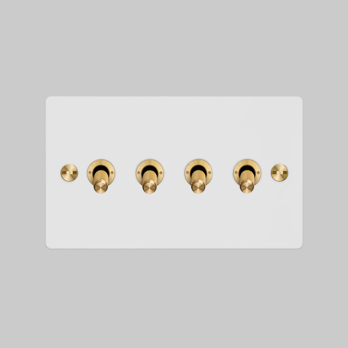 Four Gang 2 Way Light Switch in White with Brass Cross Cut Knurled Toggles