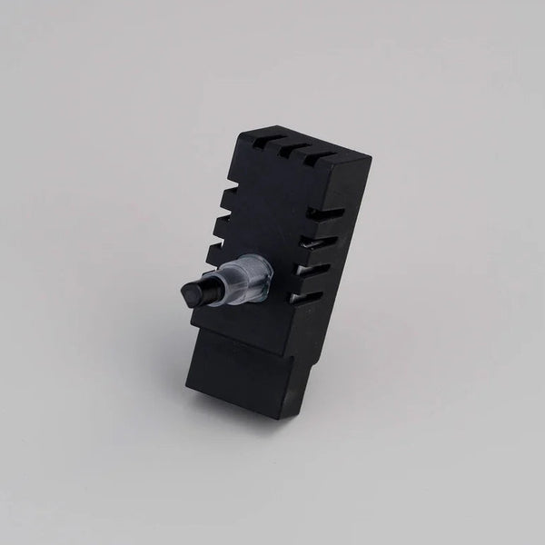Black rectangular device with a clear plastic and black knob on one side