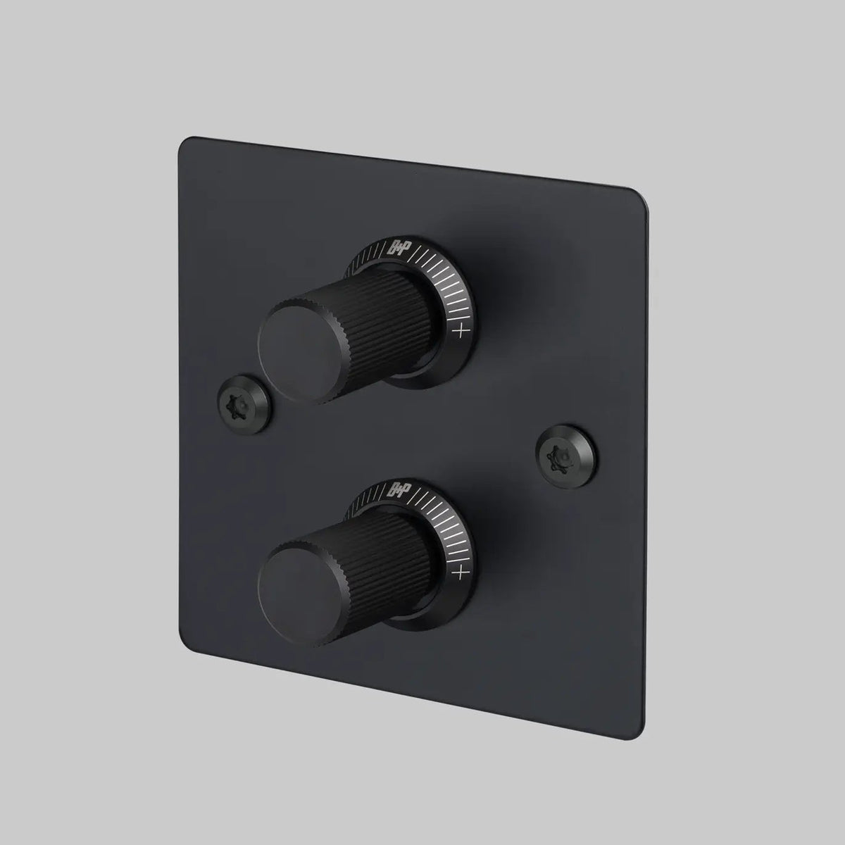 Black square wall plate with two black rotary dimmer switches and two black screws