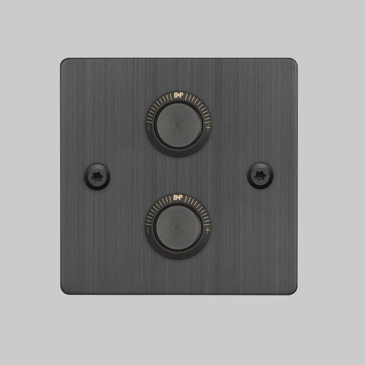 Square black metal dimmer switch with two round knobs and two visible screws