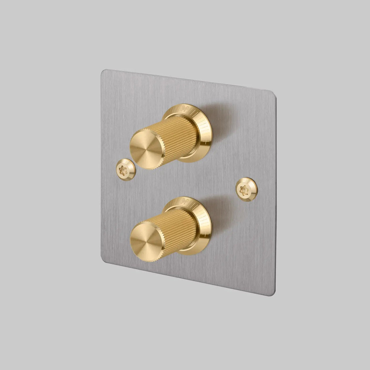 Buster and Punch two gang two way dimmer light switch in steel with brass linear knurled knobs